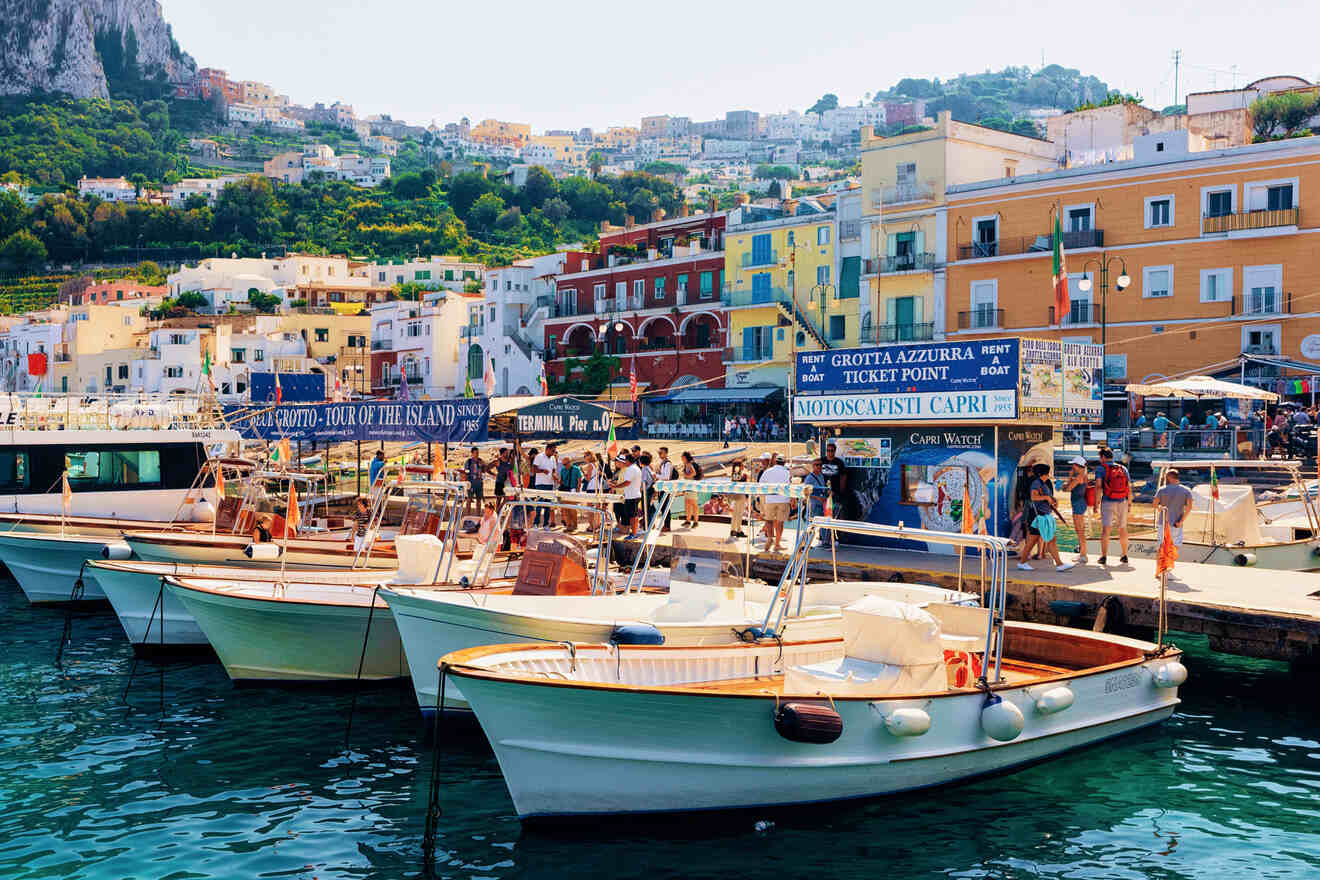 An image showing boats on the waterfront with a background of colorful buildings where to stay in Capri